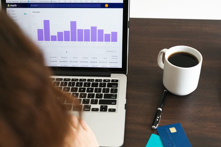 Investor analyzing Best AI ETFs 2025 performance on laptop