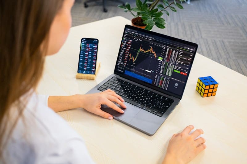 Laptop with financial charts showing AI and tech stock growth trendsin 2025